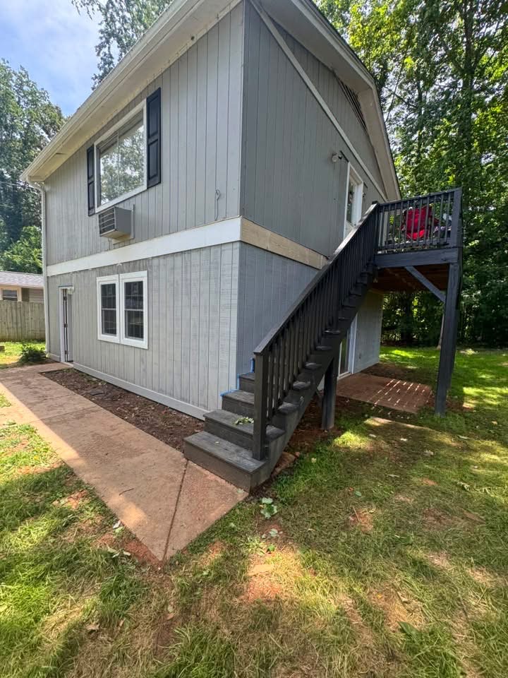 Completed remodel with new siding, trim, and refinished stairs